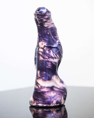 A purple sculpture named Keith the Yeti by Fantastic Kreations on a black surface.