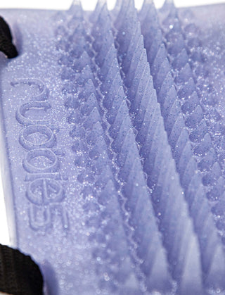 A close up of a Rubbies PEAK foam pad for external stimulation on a white surface. (Brand: Fantasticocks)